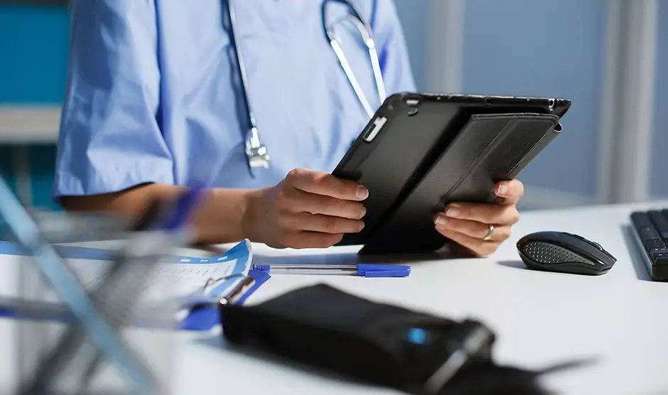 Image of medical assistant reviewing tablet information